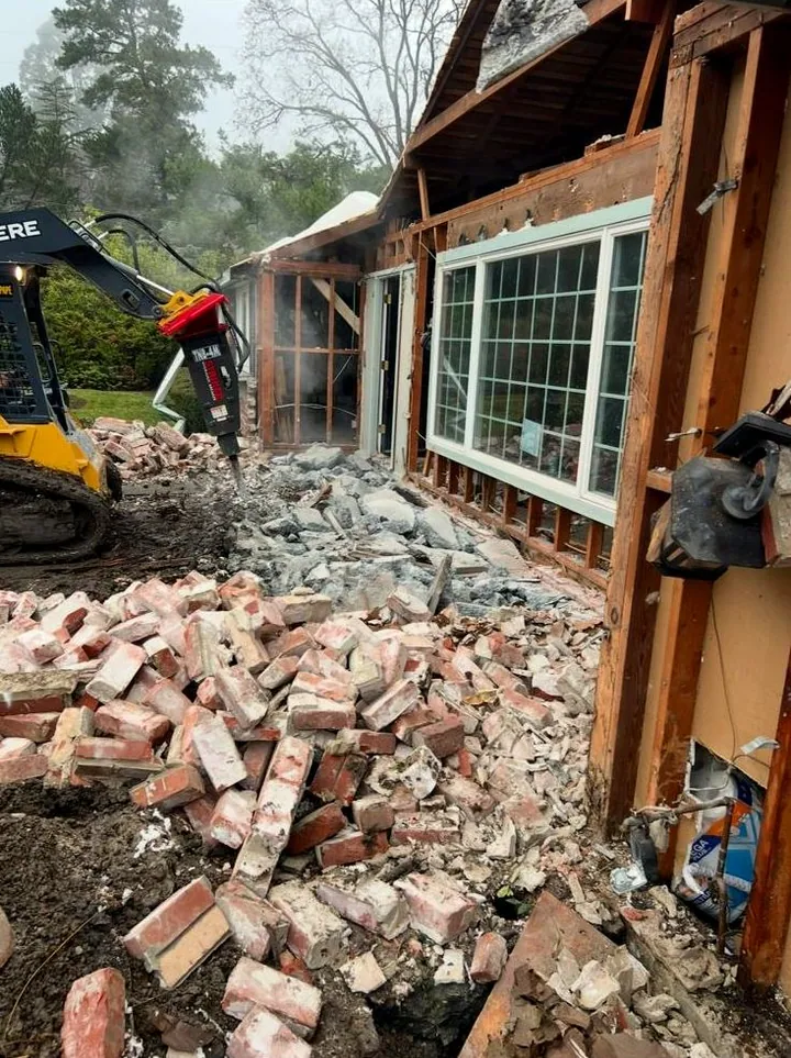 Skid steer breaker working through brick and concrete