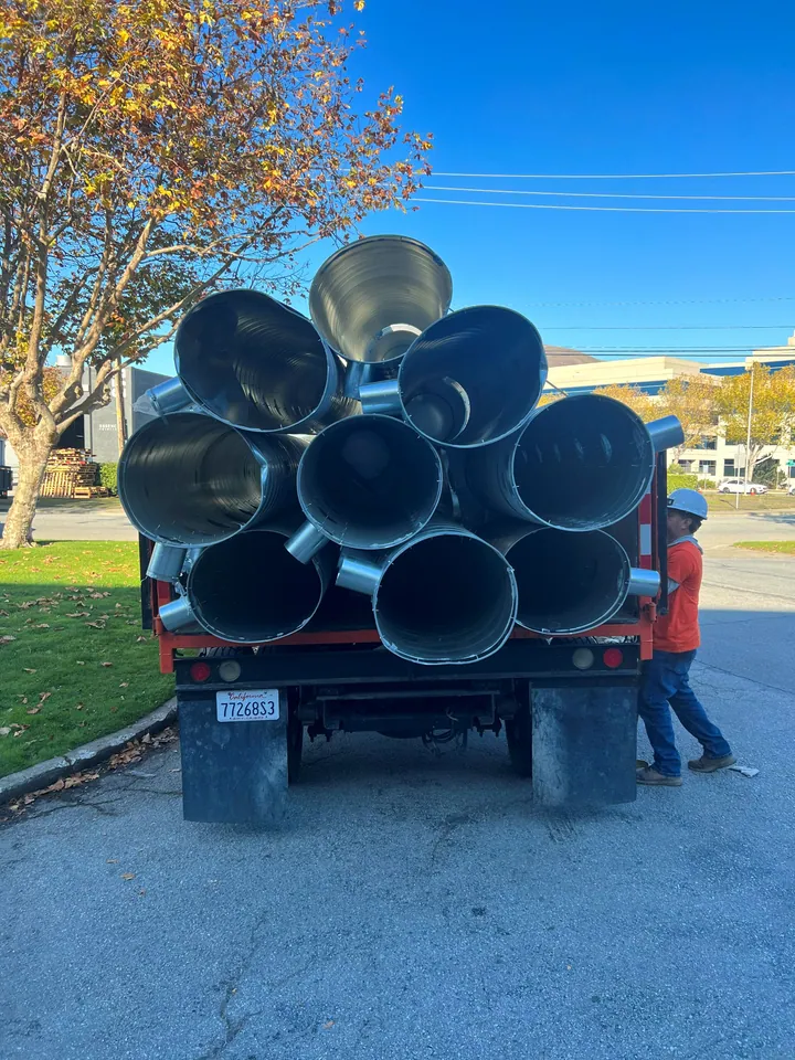 Truck loaded with large ducting removed from a plant