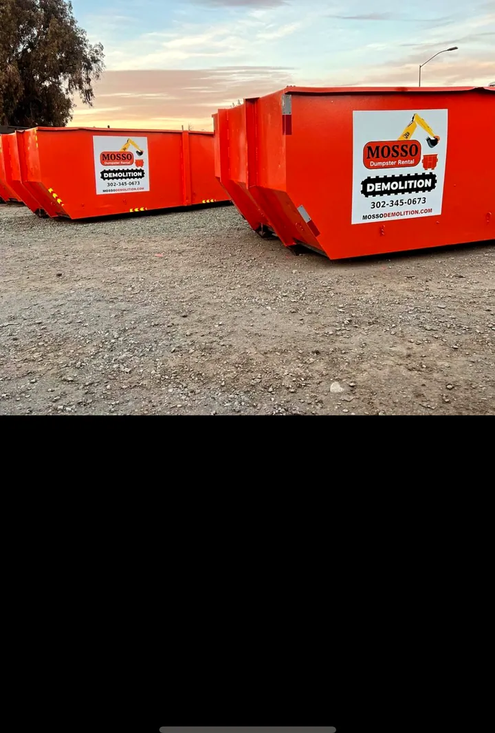 Two Mosso 20-yard roll-off dumpsters staged and ready to drop