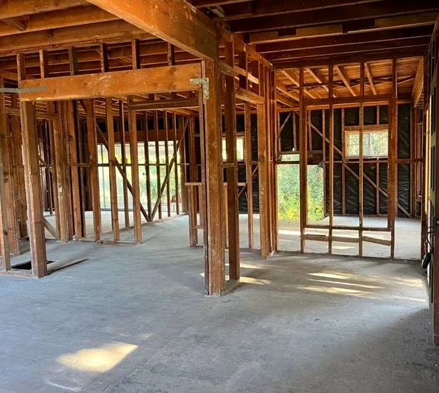 Interior gut demolition with framing exposed and floor swept
